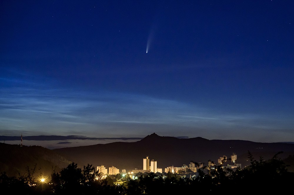 The Comet NEOWISE or C/2020 F3 is seen above Salgotarjan, Hungary, early Friday, July 10, 2020. It passed closest to the Sun on July 3 and its closest approach to the Earth will occur on July 23. (Peter Komka/MTI via AP)