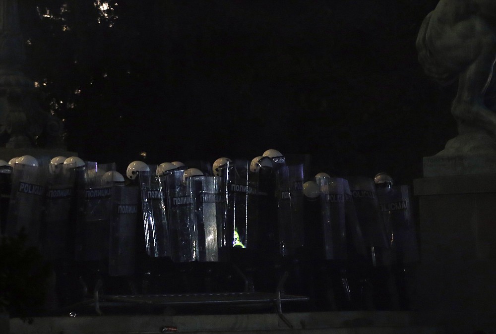 Serbian riot police guard the Serbian parliament during a protest in Belgrade, Serbia, Friday, July 10 2020. Serbia's President Aleksandar Vucic said Friday he's not worried about losing political power amid large protests against his handling of the coronavirus crisis and hard-line rule, but instead expressed his fear about the spread of the virus by the demonstrators. The spontaneous protests started on Tuesday when Vucic announced that Belgrade would be placed under a new three-day lockdown following a second wave of confirmed coronavirus infections. (AP Photo/Darko Vojinovic)