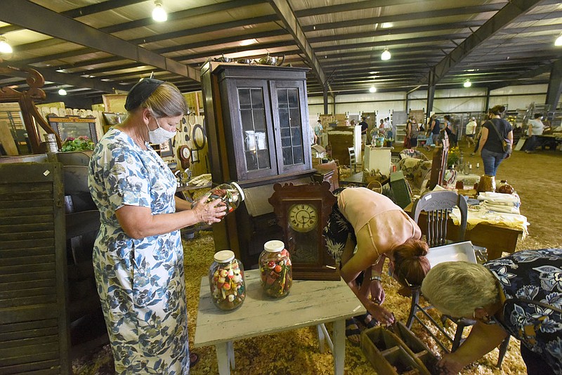 Jane Klassen checks jars filled with fishing lures on Saturday July 11 2020 at her Vintage Market Days booth at the Benton County Fairgrounds. Her wares include everything from furniture to pottery to sporting goods. Go to nwaonline.com/200712Daily/ to see more photos.
(NWA Democrat-Gazette/Flip Putthoff) story.lead_photo.caption