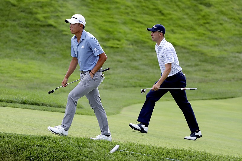 Collin Morikawa, left, and Justin Thomas walk up the 18th green during the third round of the Workday Charity Open Saturday in Dublin, Ohio. Thomas leads the field with a 16-under 200 while Morikawa trails by just three strokes. - Photo by Darron Cummings of The Associated Press