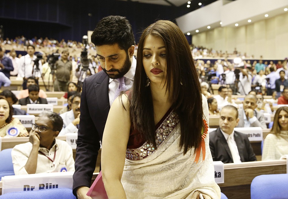 FILE- In this May 3, 2016 file photo, Bollywood couple Abhishek Bachchan, behind and Aishwarya Rai Bachchan arrive to attend the national film awards presentation ceremony in New Delhi, India. Bollywood superstar Amitabh Bachchan, his son Abhishek and two other family members including Aishwarya have tested positive for the coronavirus in Mumbai, India’s financial and entertainment capital, a government minister said Sunday. (AP Photo/Saurabh Das, File)