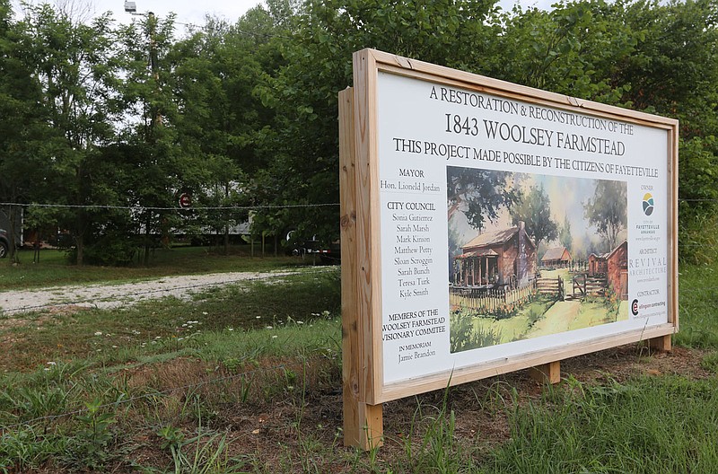 Signage is visible Friday, July 10, 2020, for the Woolsey Farmstead on Broyles Avenue in Fayetteville. The city has been working since 2014 to restore the more than 170-year-old homestead. The Woolsey family was among the first settlers of European descent in Washington County. Check out nwaonline.com/200712Daily/ and nwadg.com/photos for a photo gallery.
(NWA Democrat-Gazette/David Gottschalk)