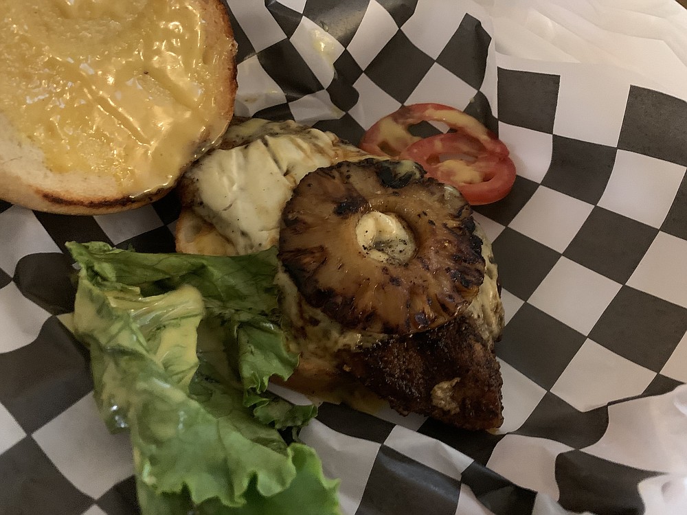The Pineapple Bird sandwich from North Bar is grilled chicken, grilled pineapple, honey mustard, lettuce and tomato on a brioche bun. (Arkansas Democrat-Gazette/Eric E. Harrison)