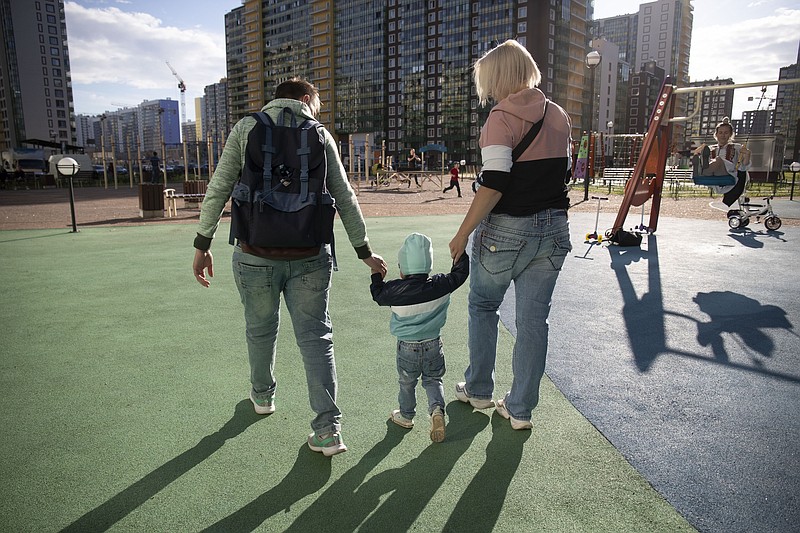 Irina, right, and Anastasia Lagutenko walk with their son, Dorian, at a playground in St. Petersburg, Russia, July 2, 2020. Their 2017 wedding wasn’t legally recognized in Russia. Any hopes they could someday officially be married in their homeland vanished July 1 when voters approved a package of constitutional amendments, one of which stipulates that marriage in Russia is only between a man and a woman. (AP Photo)