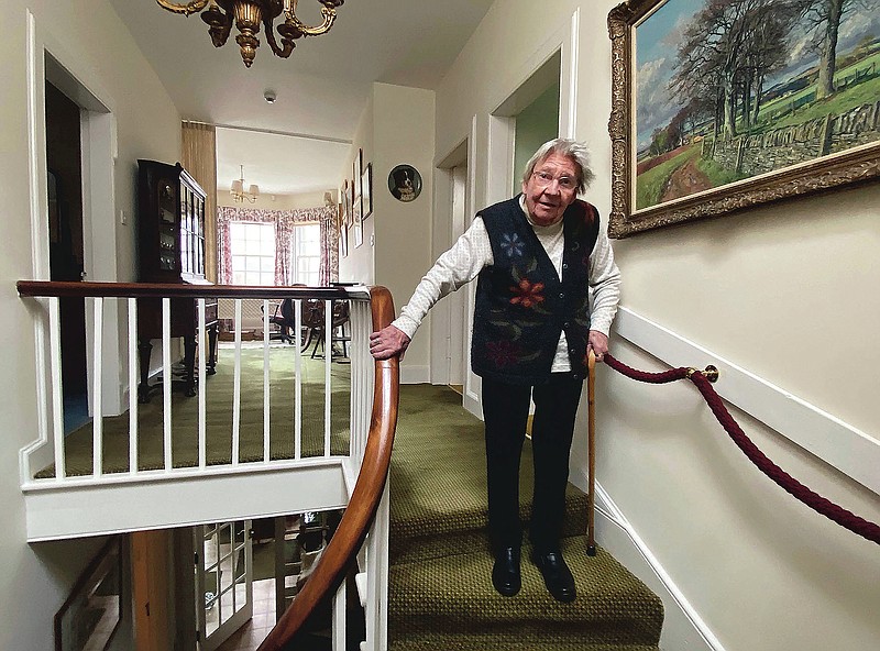In this undated family handout, Margaret Payne poses for a photo on the stairs of her home in Sutherland, Scotland. Payne, the 90-year-old grandmother who launched an epic climb to raise money for charity completed her fundraiser Tuesday, June 23, 2020 scaling her home’s stairs the equivalent of 731 meters (2,398 feet). That's enough to reach the top of the iconic Scottish peak, Suilven. The feat took her 73 days and kept her busy for 10 weeks while the nation sheltered in lockdown due to the COVID-19 pandemic. (Payne Family via AP) story.lead_photo.caption
