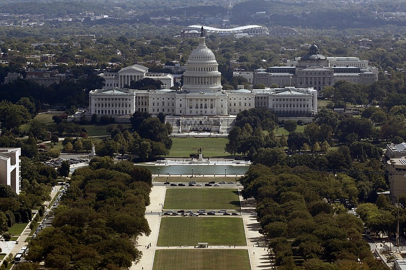 FILE - This Sept. 18, 2019, file photo shows the view of the U.S. Capitol building from the Washington Monument in Washington. The federal government incurred the biggest monthly budget deficit in history in June 2020 as spending on programs to combat the coronavirus recession exploded while millions of job losses cut into tax revenues. The Treasury Department reported Monday, July 13, 2020 that the deficit hit $864 billion last month, an amount of red ink that surpasses most annual deficits in the nation’s history and is above the previous monthly deficit record of $738 billion in April.(AP Photo/Patrick Semansky, File)