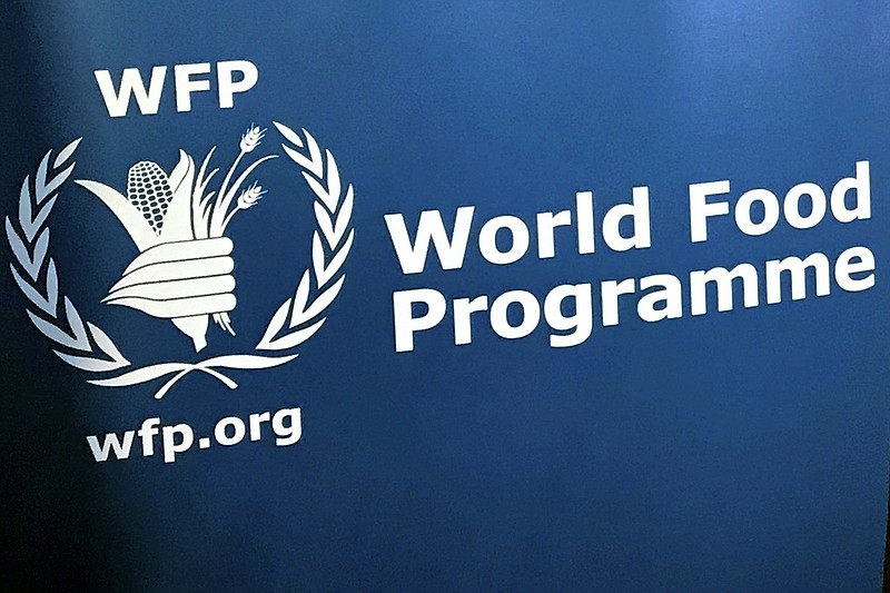 FILE - In this Nov. 6, 2017 file photo, the U.N. World Food Program's logo is seen at the agency's headquarters in New York. The United Nations says the ranks of the world’s hungry grew by 10 million last year and warns that the coronavirus pandemic could push as many as 130 million more people into chronic hunger this year. The grim assessment is contained in an annual report released Monday, July 13 2020 by the five U.N. agencies that produced it.  (AP Photo/Robert Bumstead, File)