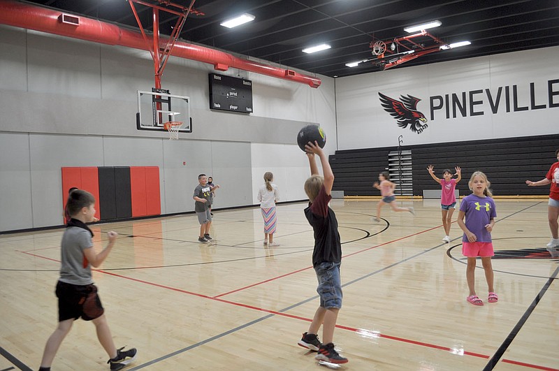 RACHEL DICKERSON/MCDONALD COUNTY PRESS A group of fourth- and fifth-graders enjoy a game of kickball in the gym at Pineville Elementary School during summer school on July 15.