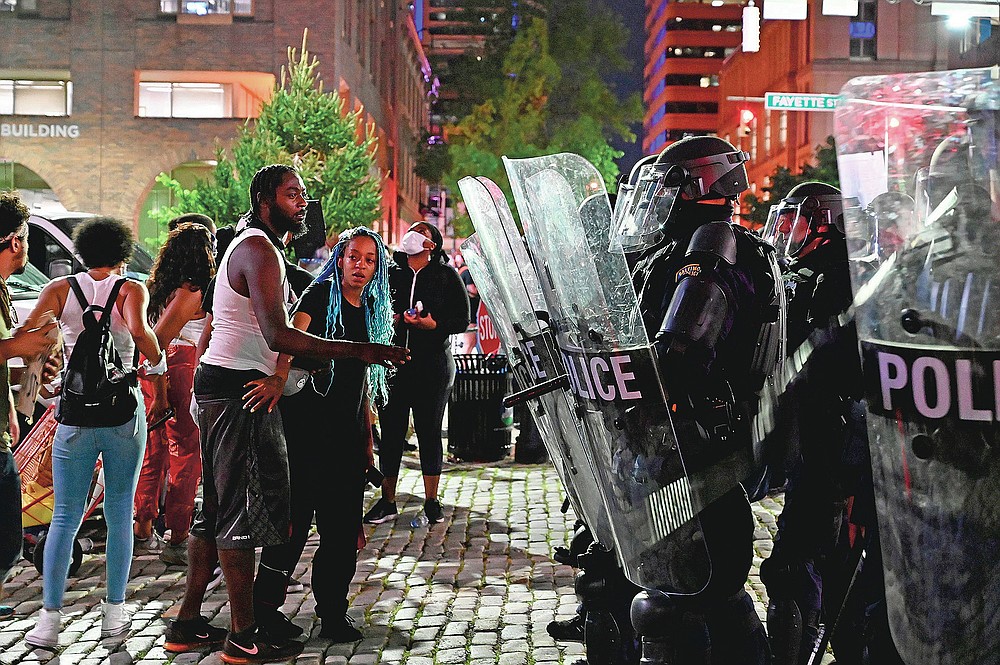 Demonstrators protest George Floyd's killing, Saturday, May 30, 2020 in Baltimore. The injustices that fueled Baltimore’s unrest five years ago still exist, activists said during recent weeks of demonstrations, as do instances of police brutality and misconduct. (Jerry Jackson/The Baltimore Sun via AP)