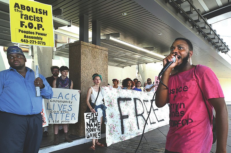Activists Ralikh Hayes, coordinator for Baltimore Bloc, right, and Rev. C.D. Witherspoon, of Peoples Power Assembly, left, lead protesters in chants against the FOP, outside the entrance to the Hyatt Regency at the Inner Harbor, where the Maryland Fraternal Order of Police will open their four-day convention, Aug. 14, 2016 in Baltimore. The injustices that fueled Baltimore’s unrest five years ago still exist, activists said during recent weeks of demonstrations, as do instances of police brutality and misconduct. (Amy Davis/The Baltimore Sun via AP)