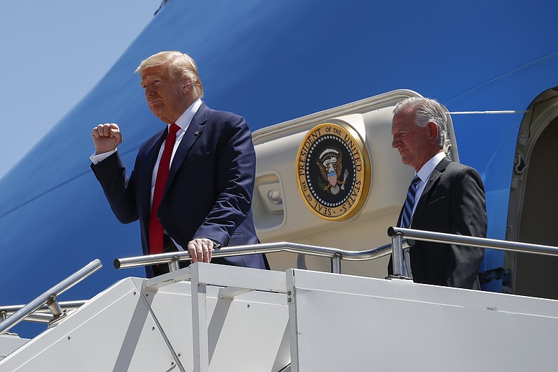FILE - In this June 11, 2020, file photo President Donald Trump gestures as he steps off Air Force One at Dallas Love Field in Dallas with Senate candidate Tommy Tuberville. Trump has endorsed Tuberville in the race, turning decisively against his former attorney general with direct appeals for Alabama voters to reject Sessions's candidacy. “Do not trust Jeff Sessions,” Trump tweeted this spring. “He let our Country down.” (AP Photo/Alex Brandon, File)