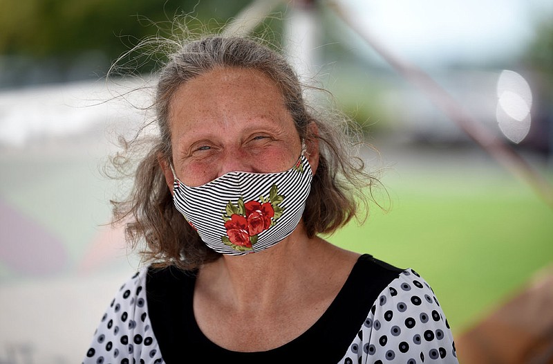 Carol Butler, market manager of the Springdale Farmers' Market, smiles behind her mask Tuesday, July 14, 2020, at the Jones Center in Springdale. The market, open Tuesday, Thursday and Saturday mornings from 7:00 a.m. to 1:00 p.m., participates in SNAP, WIC Farmers Market Program, Double Up Food Bucks, Double Your Dollars Program and the Summer Farmers Market Program. Check out nwaonline.com/200715Daily/ and nwadg.com/photos for a photo gallery.
(NWA Democrat-Gazette/David Gottschalk)