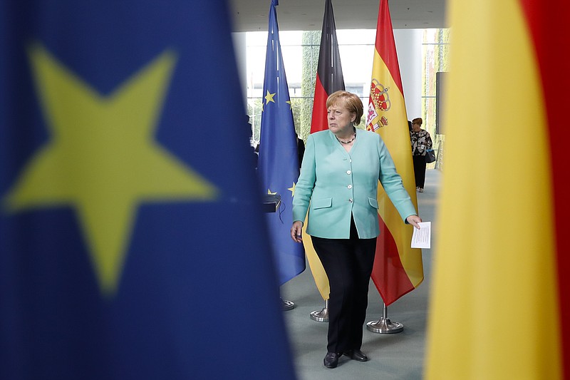 German Chancellor Angela Merkel arrives for a joint statement with the Spanish Prime Minister Pedro Sanchez prior to a meeting at the chancellery in Berlin, Germany, Tuesday, July 14, 2020. (AP Photo/Markus Schreiber, Pool)