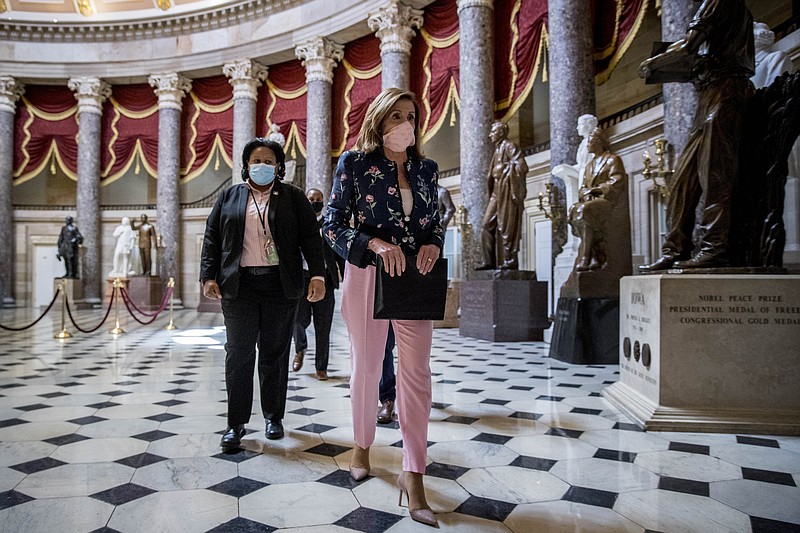 House Speaker Nancy Pelosi of Calif. walks to a news conference on Capitol Hill in Washington, Wednesday, July 15, 2020, to mark two months since House passage of "The Heroes Act" or the Health and Economic Recovery Omnibus Emergency Solutions act. (AP Photo/Andrew Harnik)