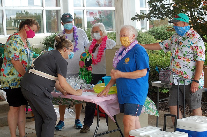 Janelle Jessen/Herald-Leader
Civitan members hand out goodie bags to Siloam Springs Nursing and Rehab employees on Saturday morning.