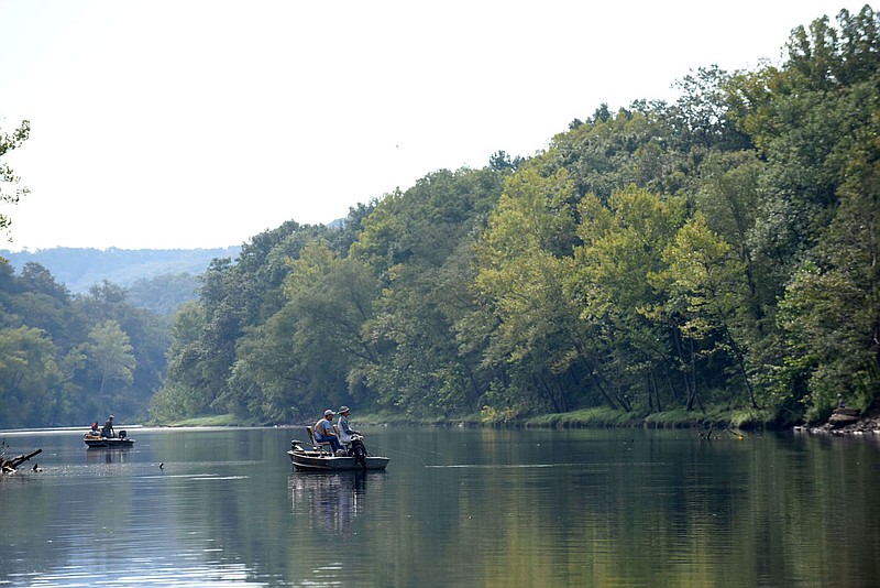 Anglers fish along the White River below Beaver Dam, also called the Beaver tailwater, in August 2019. The river is refreshing and cold during summer because water released through the dam comes from deep down in Beaver Lake.
(NWA Democrat-Gazette/Flip Putthoff)
