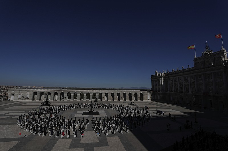 Authorities and civil society members attend a state tribute in memory of COVID-19 victims at an esplanade in Madrid's Royal Palace in Madrid, Spain, Thursday, July 16, 2020. Spain is paying homage to the nation's victims of the new coronavirus and workers who put their lives at the crossroads during the worst of the pandemic with a solemn ceremony in Madrid. (AP Photo/Manu Fernandez)