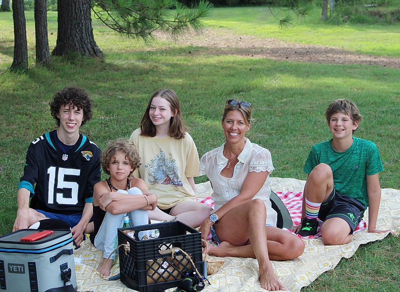 Grady Gottschalk (from left), Rowan Rains, Shannon Cash, Melissa Swann and River Rains enjoy their Apple Seeds picnic basket July 16 at Gulley Park in Fayetteville.
(NWA Democrat-Gazette/Carin Schoppmeyer) story.lead_photo.caption