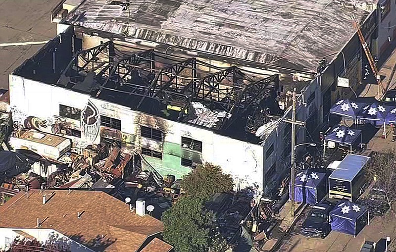 FILE - This Dec. 3, 2016, file image taken from video provided by KGO-TV shows the Ghost Ship Warehouse after a fire swept through the building in Oakland, Calif. Oakland will pay $32.7 million to settle lawsuits filed over a 2016 fire at an illegally converted warehouse dubbed the Ghost Ship that killed 36 people. The City Council authorized the settlements Thursday, July 16, 2020. (KGO-TV via AP, File)