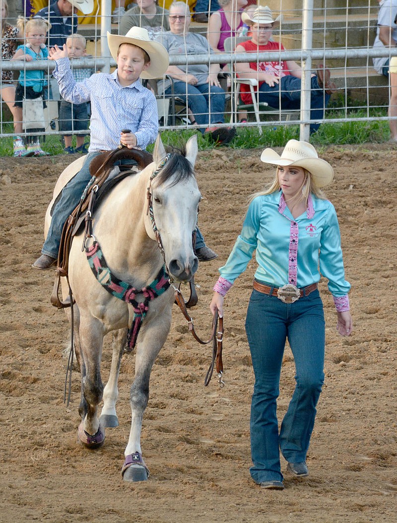 Graham Thomas/Siloam Sunday
Cale Pendergraft, left, and his aunt, Kirstie Williams, participate in the Kids Grand Entry on Thursday at the Siloam Springs Rodeo.