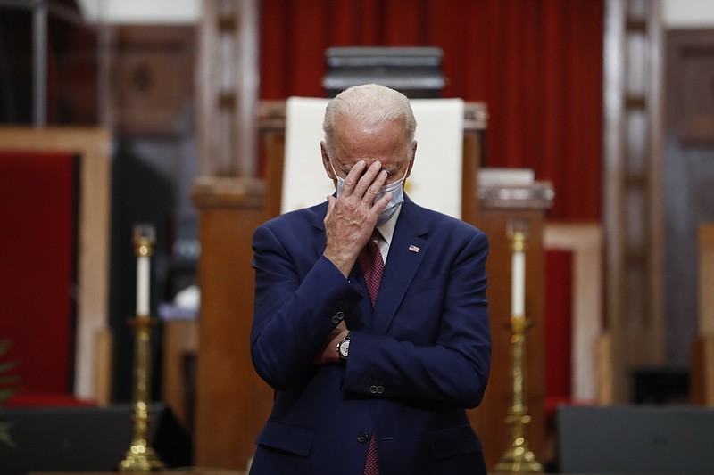 In this June 1 file photo, Democratic presidential candidate and former Vice President Joe Biden touches his face as he speaks to members of the clergy and community leaders at Bethel AME Church in Wilmington, Del. Democrats are betting on Biden’s evident comfort with faith as a powerful point of contrast in his battle against President Donald Trump. - AP Photo/Andrew Harnik