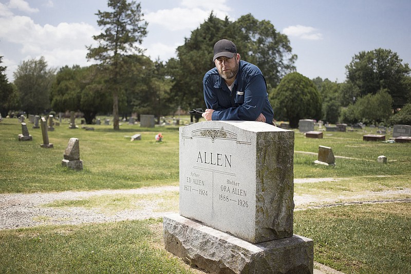 Brian Culpepper, a crime scene technician at the Rogers Police Department, poses for a portrait, Friday, July 17, 2020 at the gravesite of Ed Allen at a cemetery in Rogers. Allen was a constable in Rogers in 1924. He was killed when his car was hit by a runaway horse and buggy. Culpepper is trying to get Allen's name on the law enforcement officer's memorial wall in Washington D.C. but he needs to find a family member. Check out nwaonline.com/200718Daily/ for today's photo gallery. 
(NWA Democrat-Gazette/Charlie Kaijo)