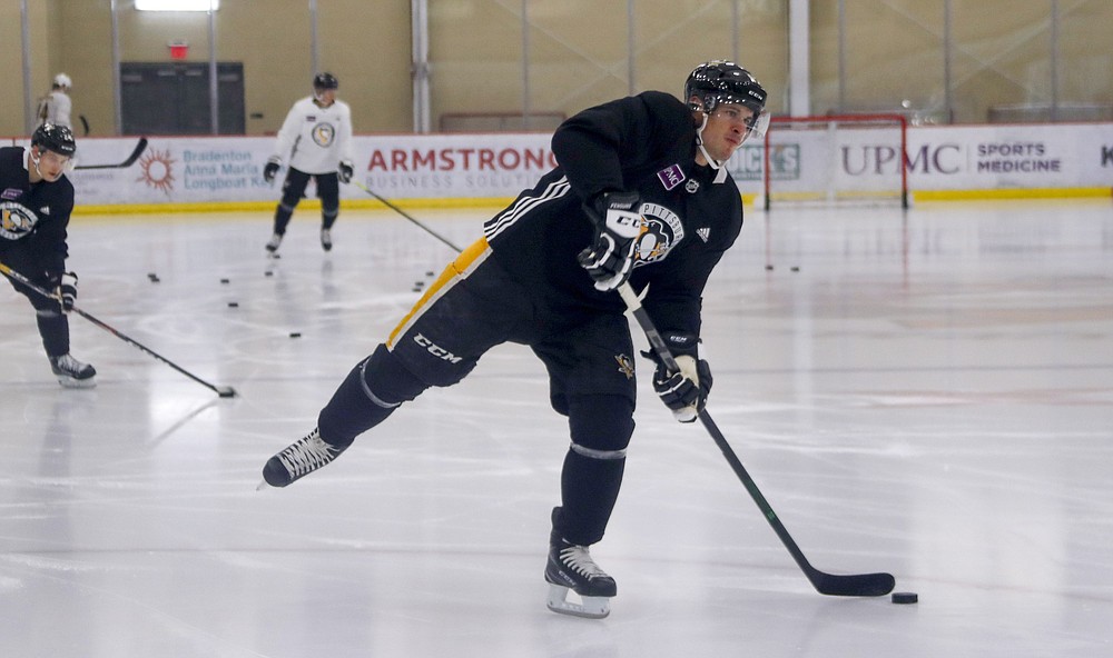 FILE - In this Sept. 13, 2019, file photo, Pittsburgh Penguins' Sidney Crosby takes part in the NHL hockey team's practice in Cranberry Township near Warrendale, Pa. Teams began opening their training facilities Monday, June 8. Crosby and some teammates are already on the ice at their shiny practice rink, and the Blue Jackets reported eight or nine players skating daily in different groups. (AP Photo/Keith Srakocic, File)