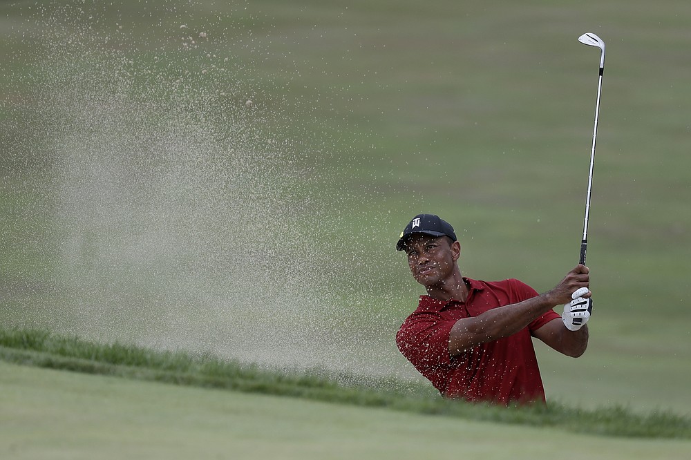Tiger Woods hits from a bunker toward the 18th green during the final round of the Memorial golf tournament, Sunday, July 19, 2020, in Dublin, Ohio. (AP Photo/Darron Cummings)