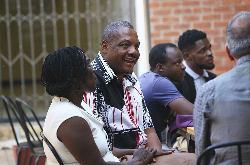 Zimbabwe journalist Hopewell Chino'ono, center, during the launch of his documentary, State of Mind, in Harare, in this Oct. 10, 2018 photo. Zimbabwe police on Monday July 20, 2020, swooped in and detained Hopewell Chino'ono, the prominent journalist and opposition leader, ahead of anti-government protests planned for the end of this month, their lawyers said. (AP Photo/Tsvangirayi Mukwazhi)