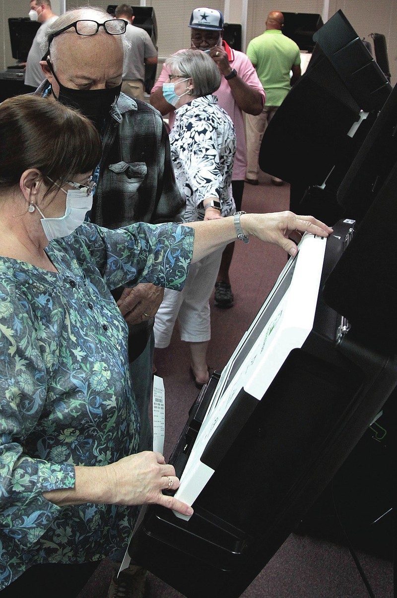 A technician with Election Systems & Software, the voting system vendor that is supplying new voting equipment to the state, explains to Stuart "Stu" Soffer, a member of the Jefferson County Election Commission, how to operate the new ES&S ExpressVote voting system during a training session on Monday. The county recently received nearly $1 million in new voting equipment to replace the aging ES&S iVotronics voting system that had been in use since 2006. County election officials trained on the new equipment Monday and are scheduled to wrap up training today. (Arkansas Democrat-Gazette/Dale Ellis)