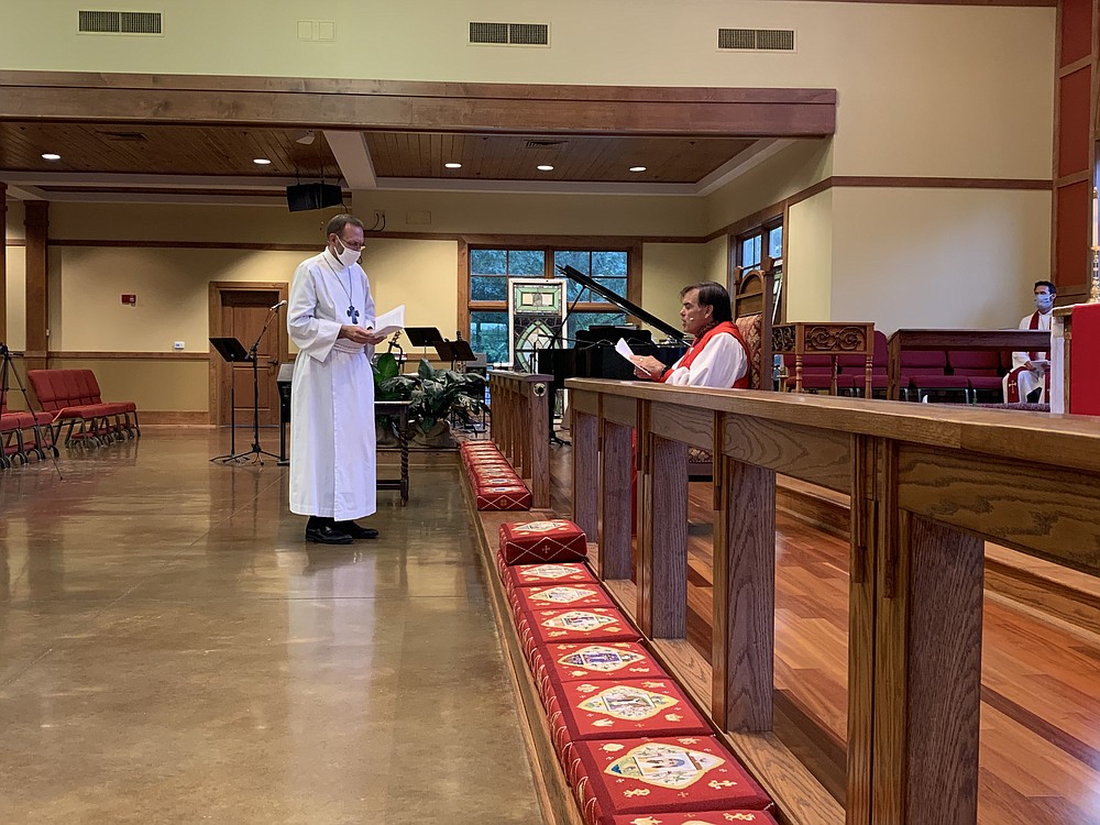 The Rt. Rev. Phillip Jones, lead bishop in the Anglican Mission in America (right), exhorts Dr. Nate Smith in the responsibilities of Anglican priesthood. Smith was ordained as a priest in the faith July 15 at St. Andrew’s Church in Little Rock.
(Special to the Democrat-Gazette)