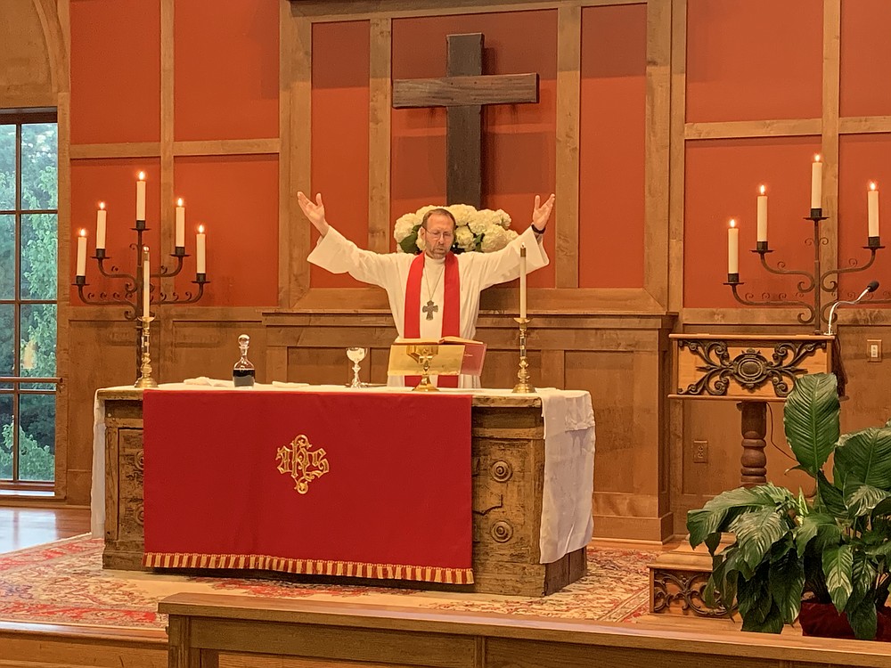 Dr. Nate Smith invites those gathered at St. Andrew’s to sing the Doxology at Smith’s ordination service July 15.
(Special to the Democrat-Gazette)