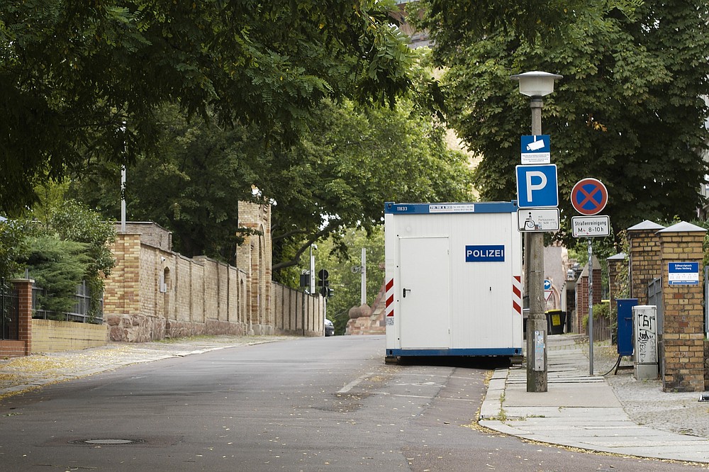 A structure used by police is seen in front of the synagogue in Halle, Germany, Monday, July 20, 2020. The trial of a heavily armed attacker who wanted to force his way into the synagogue begins on Tuesday, July 21, 2019 in Magdeburg. After not entering the synagogue, the man shot two passers-by.(AP Photo/Markus Schreiber)