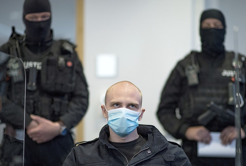 Accused Stephan Balliet sits in the courtroom of the regional court at the beginning of the trial in Magdeburg, Germany, Tuesday, July 21, 2020. Balliet is charged with 13 crimes including murder and attempted murder, for a Yom Kippur attack on a synagogue on Oct. 9 in the eastern German city of Halle,  that is considered one of the worst anti-Semitic assaults in the country's post-war history.  (Hendrik Schmidt/dpa via AP)