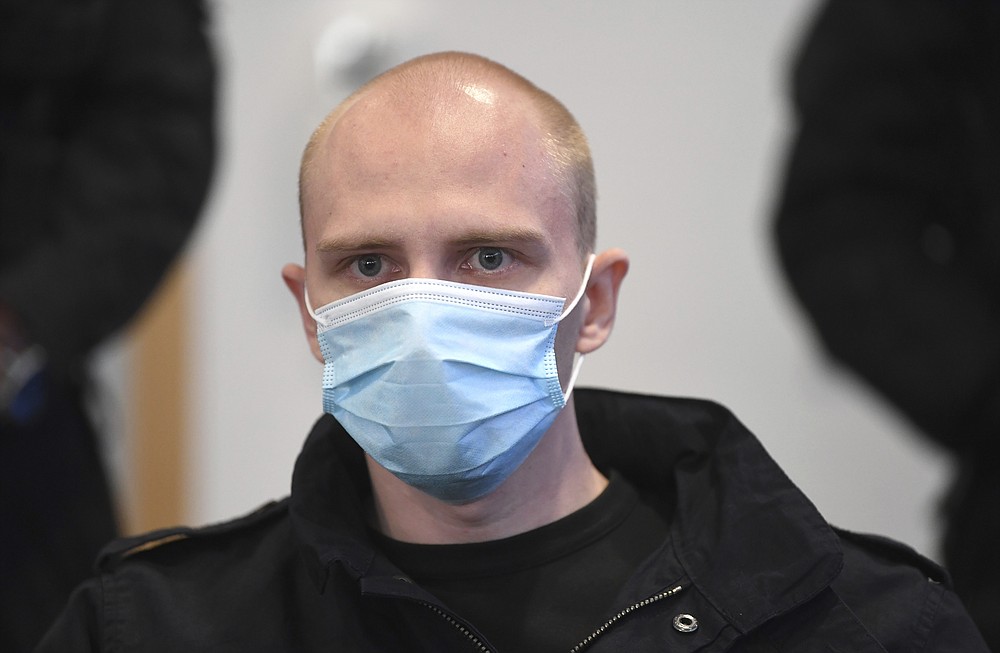 Accused Stephan Balliet sits in the courtroom of the regional court at the beginning of the trial in Magdeburg, Germany, Tuesday, July 21, 2020. The Federal Prosecutor's Office accuses the assassin of Hall 13 of criminal offences, including murder and attempted murder. On 9 October 2019, on the highest Jewish holiday Yom Kippur, he had attempted to cause a bloodbath in the synagogue in Halle. (Hendrik Schmidt/dpa via AP)