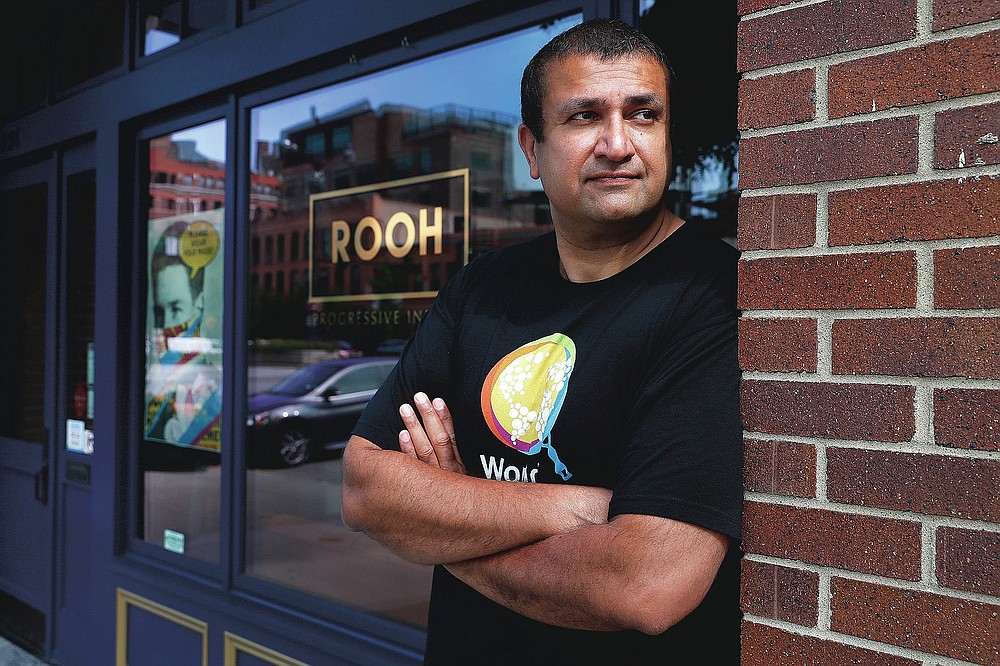 Manish Mallick, owner of the Indian restaurant ROOH, poses for a portrait outside the West Loop restaurant in Chicago on Tuesday, July 14, 2020. When Mallick opened last year, he was focused on building his business and getting rave reviews about the eatery's "progressive Indian cuisine" from the city's top critics. Now some of his biggest fans are on the city's South Side, where he regularly delivers hundreds of meals to those hardest-hit by the pandemic. (AP Photo/Charles Rex Arbogast)