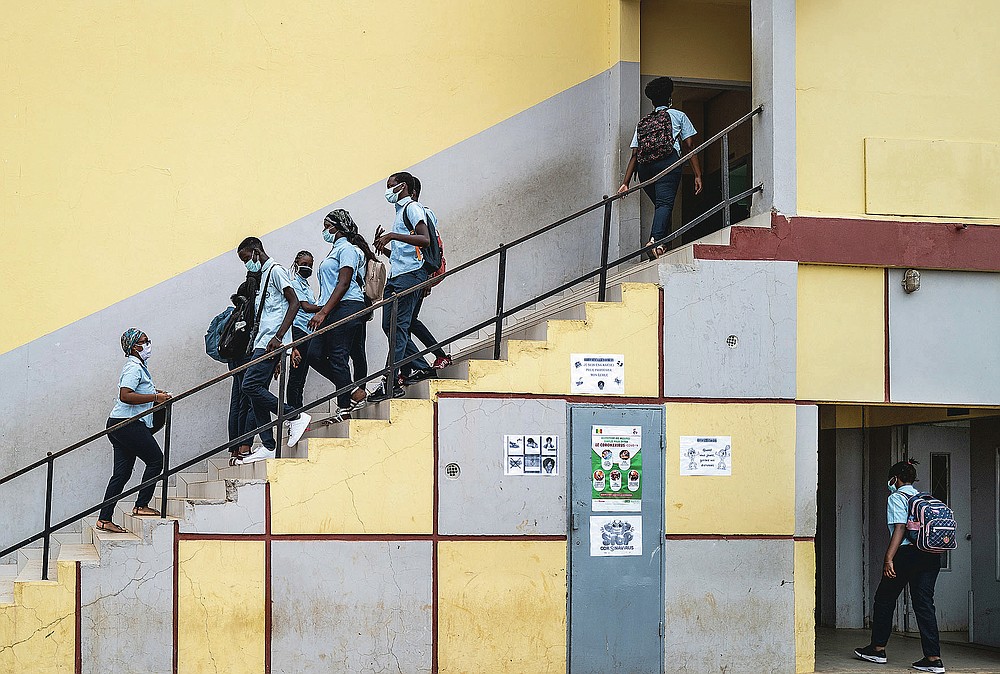 FILE - In this June 25, 2020, file photo, Senegalese students wear masks to curb the spread of the coronavirus as they return to classes on the first day back after more than three months away, at the Sacre Coeur college in Dakar, Senegal. The options for African students eager to keep studying while schools remain closed because of the coronavirus pandemic seems varied, but the reality for many is that they will fall behind and possibly drop out of school forever, worsening inequality on an already unequal continent. (AP Photo/Sylvain Cherkaoui, File)