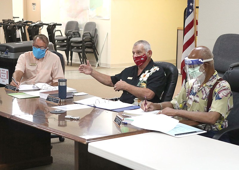 Garland County Election Commissioners Ralph Edds, left, and Elmer Beard, right, take notes as Chairman Gene Haley speaks at county election headquarters Wednesday. The panel discussed preparations for the Nov. 3 general election. - Photo by Richard Rasmussen of The Sentinel-Record