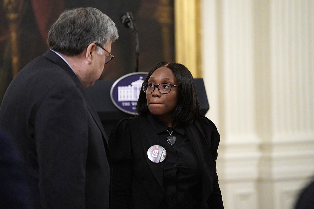 LeGend Taliferro's mother Charron Powell speaks with Attorney General William Bar during an event on "Operation Legend: Combatting Violent Crime in American Cities," in the East Room of the White House, Wednesday, July 22, 2020, in Washington. (AP Photo/Evan Vucci)