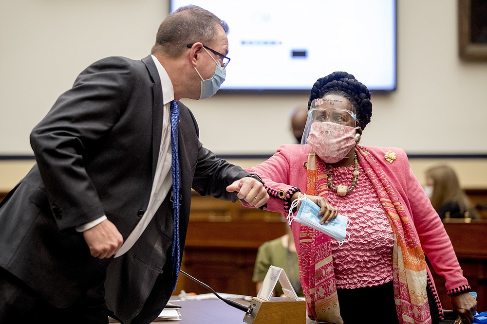 Federal Emergency Management Agency Administrator Peter Gaynor, left, greets Rep. Sheila Jackson Lee, D-Texas, right, as he arrives to testify before a House Committee on Homeland Security meeting on Capitol Hill in Washington, Wednesday, July 22, 2020, on the national response to the coronavirus pandemic. (AP Photo/Andrew Harnik, Pool)