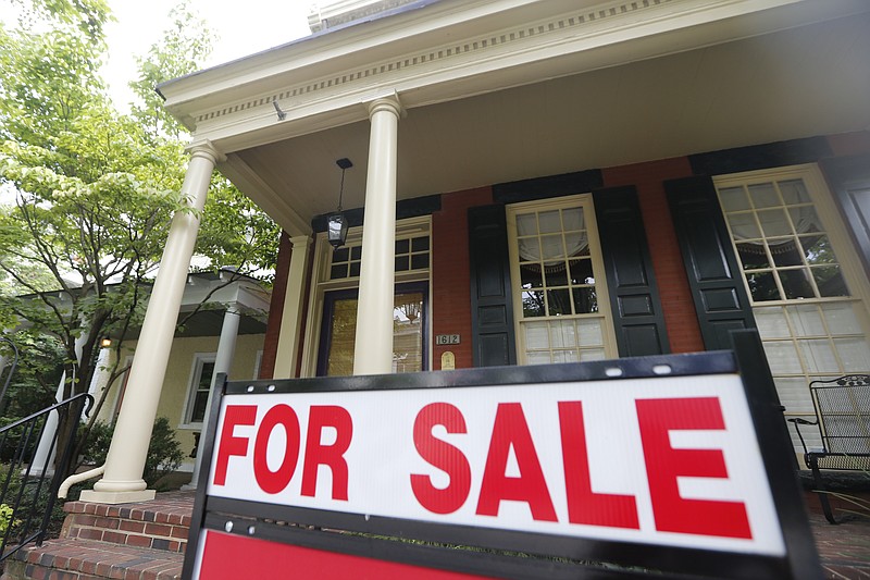 FILE - In this Aug. 16, 2019 file photo a for sale signs beckon buyers to homes along Park Avenue in Richmond, Va.  Average rates on long-term mortgages rose this week for the first time since June 25, 2020, after weeks of marking new record lows.   (AP Photo/Steve Helber)