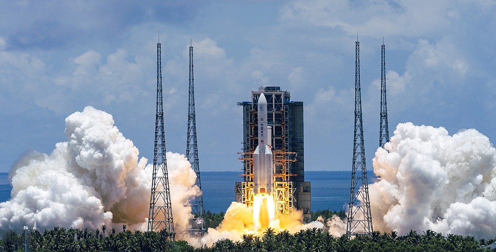 In this photo released by China's Xinhua News Agency, a Long March-5 rocket carrying the Tianwen-1 Mars probe lifts off from the Wenchang Space Launch Center in southern China's Hainan Province, Thursday, July 23, 2020. China launched its most ambitious Mars mission yet on Thursday in a bold attempt to join the United States in successfully landing a spacecraft on the red planet. (Cai Yang/Xinhua via AP)