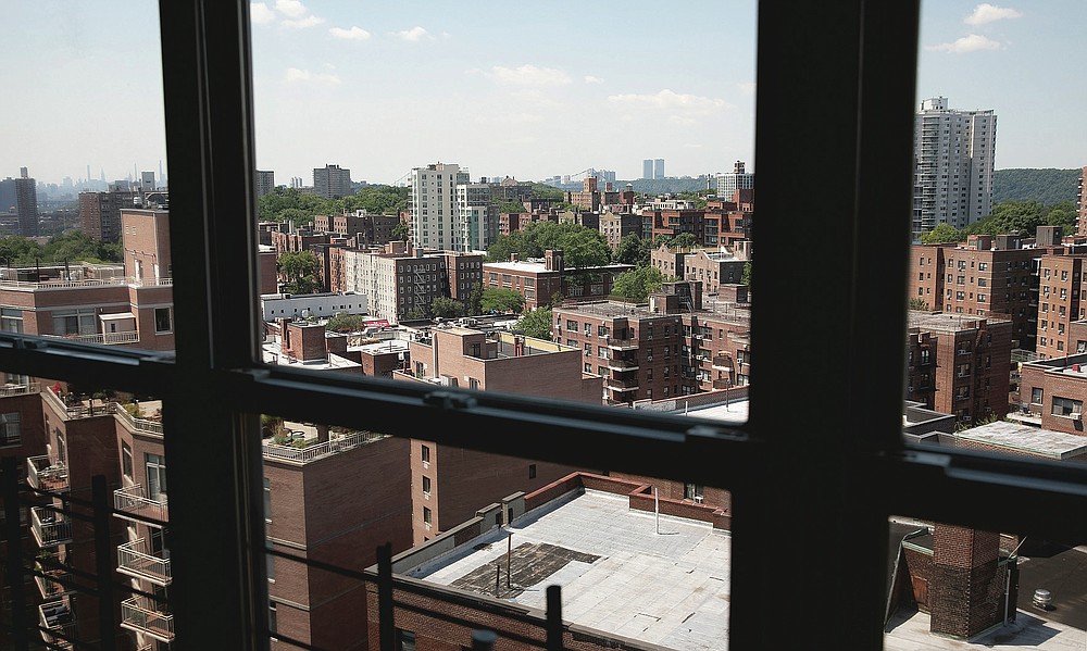 Joyce and Anil Lilly's 14th floor apartment overlooks other apartment buildings, Tuesday, July 21, 2020, in The Bronx borough of New York. They have bought a house an hour's drive north of the city, amid the coronavirus pandemic. "Because we were locked into the apartment for three months, a solid three months, I feel like I'm getting out of prison and I want to run as far away as possible," said Joyce. (AP Photo/Mark Lennihan)