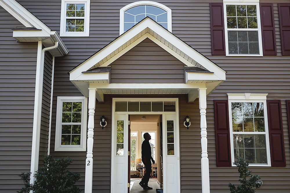 Anil Lilly tours his new home, Tuesday, July 21, 2020, in Washingtonville, N.Y. New Yorkers anxious after weathering the worst of the coronavirus pandemic are fueling a boom in home sales and rentals around the picturesque towns and wooded hills to the north. Real estate brokers and agents describe a red-hot market recently, with many house hunters able to work from home. (AP Photo/John Minchillo)