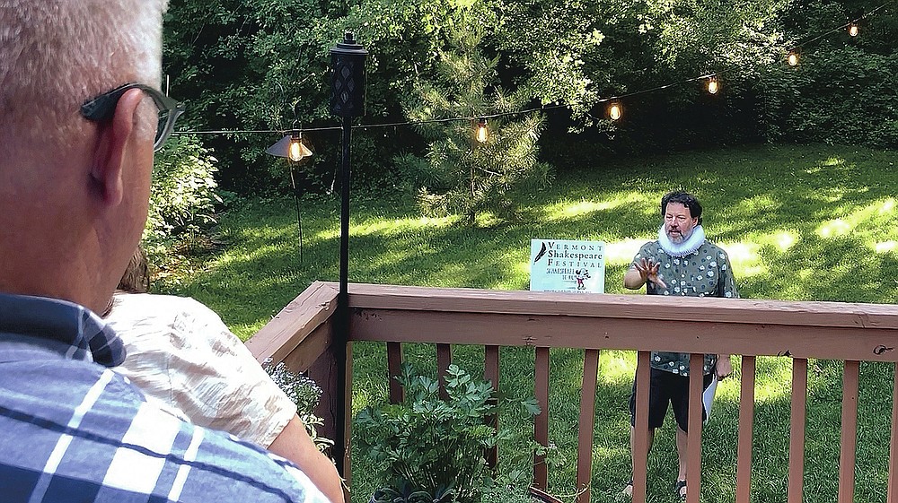 Homeowners Jean Andre, foreground, and Jen DeBedout watch John Nagle, of the Vermont Shakespeare Festival, perform "Shakespeare," in their backyard, Thursday, June 25, 2020, in Burlington, Vt. The idea for the program known as "Shakespeare to You," or "Bard to Your Yard," was conceived as a way to keep live theater alive at a time when many social activities are being postponed or canceled amid the coronavirus pandemic. Actors with the festival have done more than 30 performances, live, online and by telephone. (AP Photo/Wilson Ring)