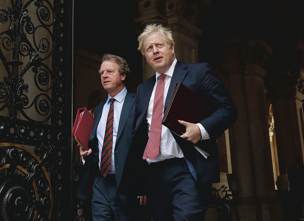 FILE - British Prime Minister Boris Johnson walks with Britain's Secretary of State for Scotland Alister Jack, left, into Downing Street, after attending a cabinet meeting at the Foreign Office in London on July 21, 2020. The countries which top the rankings of COVID-19 deaths globally are led by populist, mold-breaking leaders like Johnson. The U.S., Brazil, the United Kingdom and Mexico all are led by leaders who have been skeptical of the scientists and who initially minimized the disease. And their four countries alone account for half of the total 585,000 COVID-19 deaths worldwide so far, according to statistics tracked by Johns Hopkins University. (AP Photo/Matt Dunham, File)