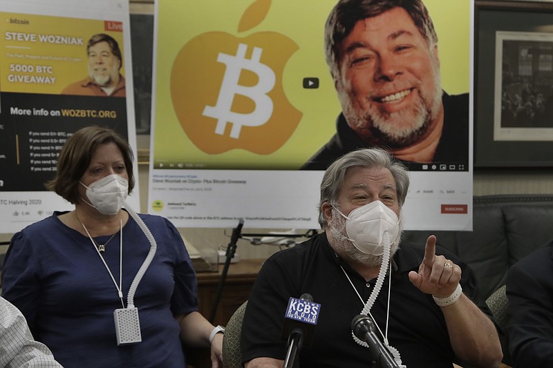 Apple co-founder Steve Wozniak, right, gestures beside his wife Janet Hill during a media conference on Thursday, July 23, 2020, in Burlingame, Calif. Wozniak is launching a legal attack against Google's YouTube video site for allowing con artists to use him as a pawn in a Bitcoin scam believed to have heisted millions of dollars from people around the world. (AP Photo/Ben Margot)