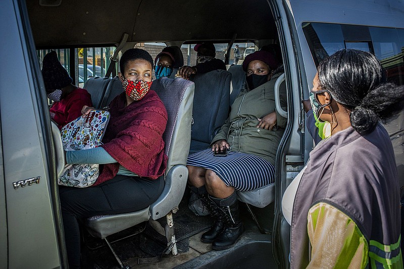 Passengers in a minibus taxi wear protective face masks at the Randburg taxi rank in Johannesburg on May 14, 2020. MUST CREDIT: Bloomberg photo by Waldo Swiegers.