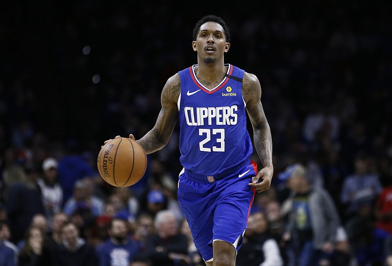 FILE - In this Feb. 11, 2020, file photo, Los Angeles Clippers' Lou Williams brings the ball up during the team's NBA basketball game against the Philadelphia 76ers in Philadelphia. Clippers coach Doc Rivers says Williams is expected to join the team for the NBA’s restart in Florida. Williams has described himself as “50-50” on whether he would finish out the pandemic-interrupted season because he didn’t want to distract from the ongoing push for social justice in the wake of George Floyd’s death while in police custody. (AP Photo/Matt Slocum, File)