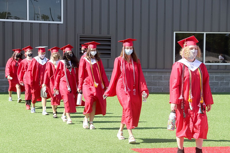 LYNN KUTTER ENTERPRISE-LEADER
Farmington's 2020 graduates, all wearing masks because of the coronavirus pandemic, file into Cardinal Stadium on Friday morning to "Pomp and Circumstance," normally played by the high school band but this time played over the sound system. The Class of 2020 had 187 graduates.